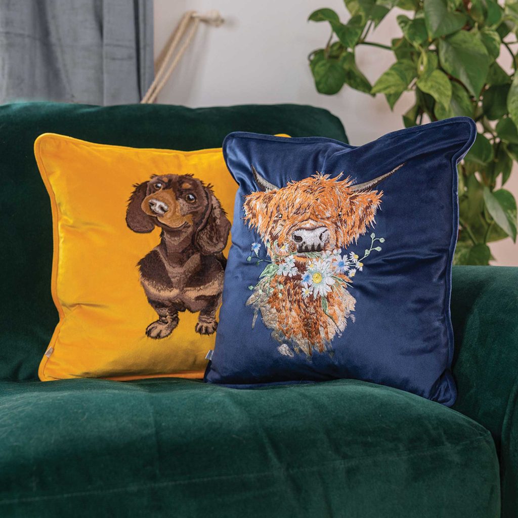 Yellow Sausage Dog cushion, and blue highland cow cushion