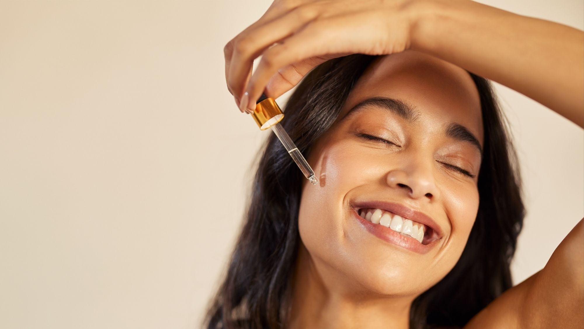 Woman applying facial serum with a dropper for Estée Lauder at Fields of Sidmouth